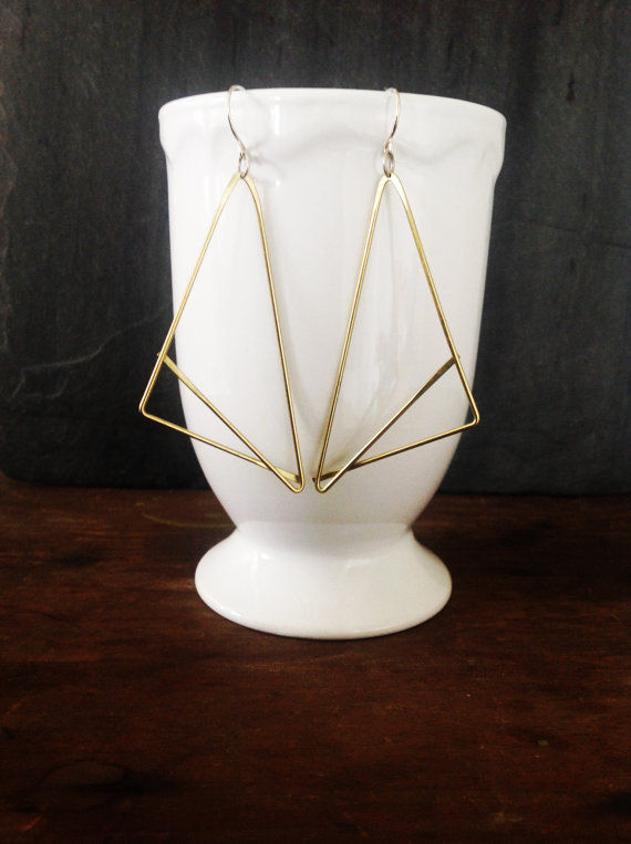 Thumbnail: Fox earrings hanging from a white mug cup, earrings take up about 2/3  of the cup's height. 