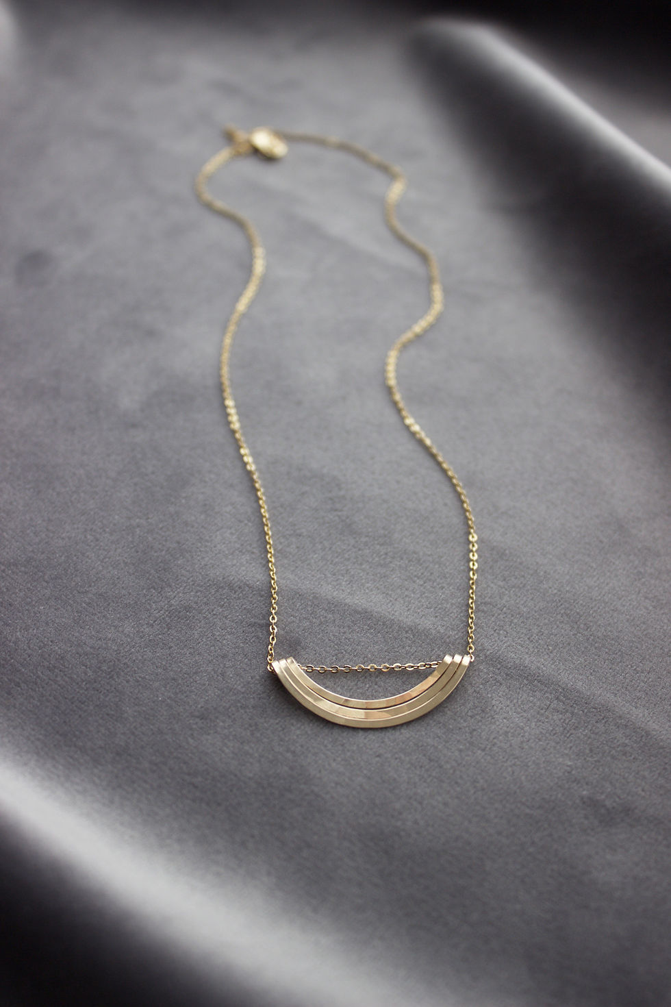 Thumbnail: Gold necklace velvet background. Necklace sits just right of center frame.