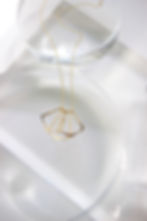 Gold Fill Flutter necklace, a necklace that resembles an abstract version of a butterfly. Design features three overlapping half diamonds that assemble to mimic the shape of a moth or butterfly. 