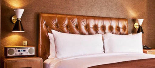Tufted brown leather headboard installed in boutique hotel.