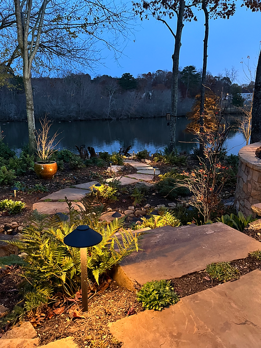 Residential lakeside landscape with custom hardscape and outdoor living design in Cumming
