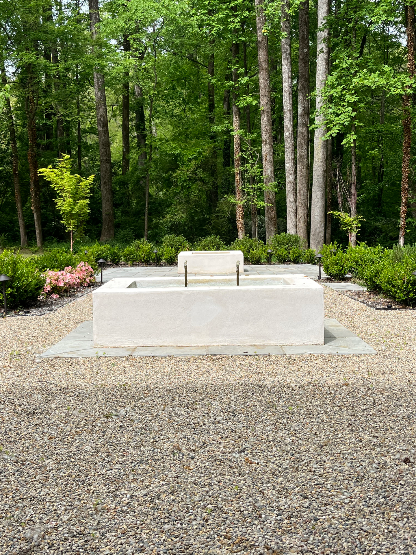 water feature, fire pit, and stone patio in a courtyard design in Decatur, GA