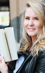 Kelly Finley holding an open book.