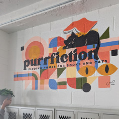 Large, colorful mural featuring the logo of a small business