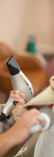 Stylist blow drying client hair at Calla Blow Dry bar in Pinecrest Florida