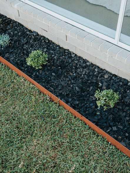 Brown metal edging borders garden bed