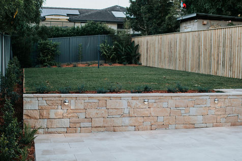 Landscaped backyard with retaining wall