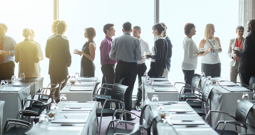 delegates in smart clothing drinking at a diversity and inclusion training seminar