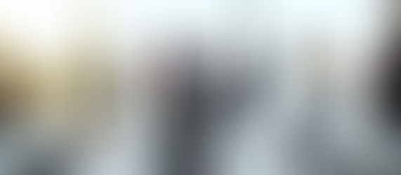 A group of business professionals networking in a bright, modern conference room, symbolising trust and relationship-building in professional services.