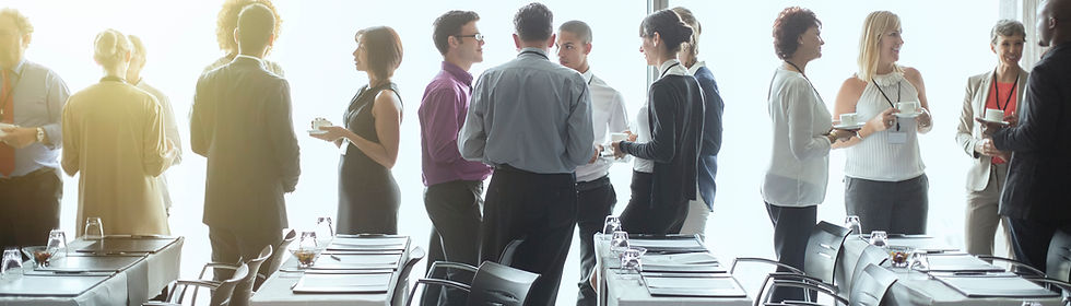 stock image of people milling with coffee in hand at a conference