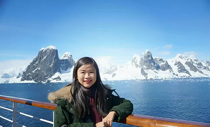 Adventurous photo of Yaya visiting Antarctica, featuring the pristine shores and majestic mountains of the icy continent as a captivating backdrop, showcasing the unique beauty of this remote and untouched destination.