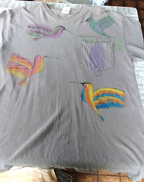 Dark grey large tshirt. 4 Painted hummingbirds in various colors surrounding a wisteria bush which is painted on the pocket. $45