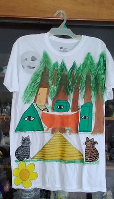 Men's Large white tshirt. Image is a bathub in the woods with steps being guarded by cats underneath. The steps lead to a door in a tre which take you to the bathtub. Thre are huge candles around the tub. Huge pine trees and a full moon. One cat is grey tabby and on cat is orange tabby. There is a yellow and orange flower on the bottom right side where a bleedthrough of paint happened but is now covered with the flower.