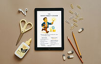 Workspace with scissors, pencils, and a tablet displaying PMTales creature cards — Workshop Pack visual