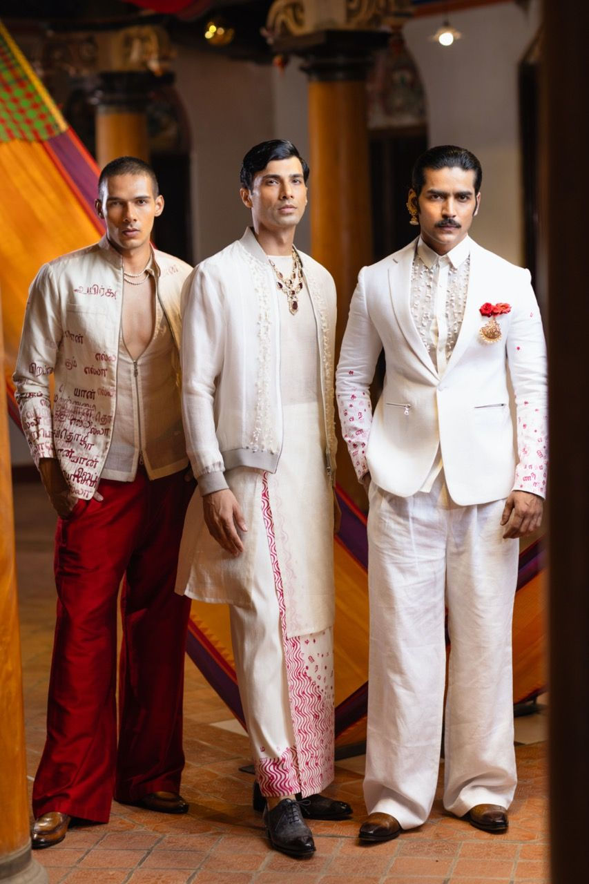 Men elegantly blend tradition and modernity in tailored suits and veshtis, showcasing a stylish fusion of cultural attire.