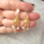 Mayan Medallion Moonstone & Quartz Earrings on hand for scale.