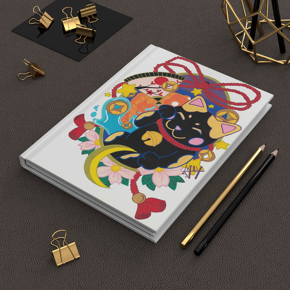 White notebook with a colorful Maneki Neko design, next to pencils