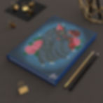 Blue journal with dark winged creature and roses cover