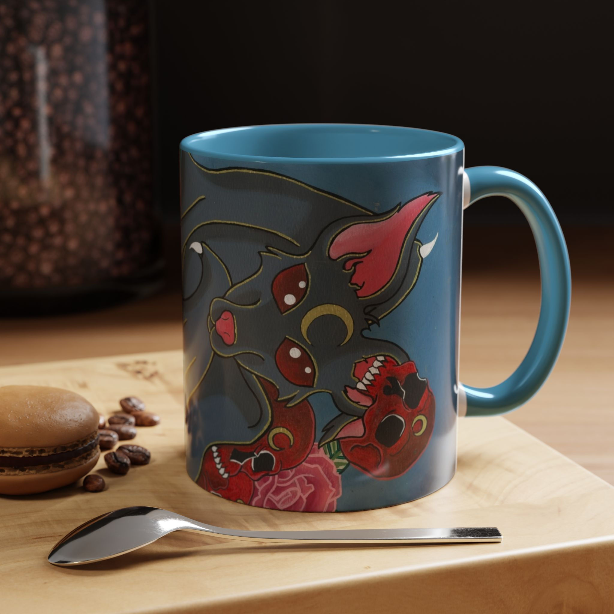 Blue mug with octopus skull design, red roses, coffee beans, macaron.
