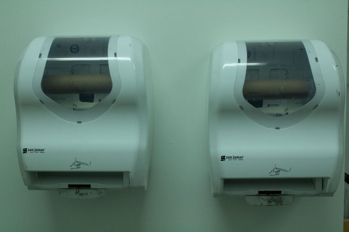 Two empty automatic paper towel dispensers.