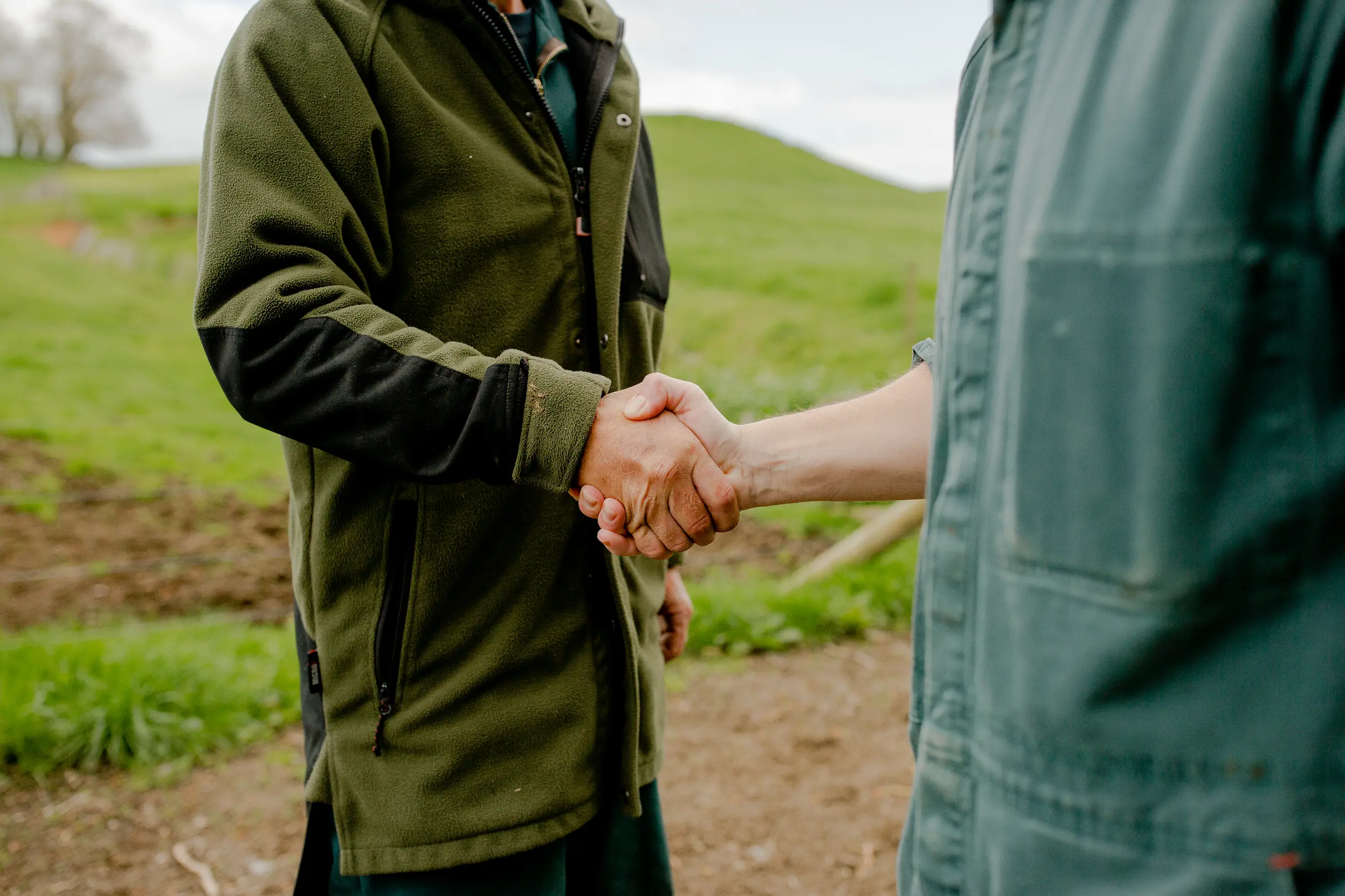 Close up of two farmers shaking hands