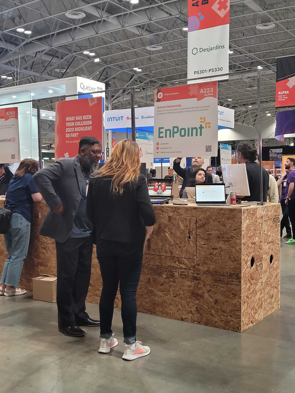Julia showing a man a demo of the EnPoint software at their conference booth