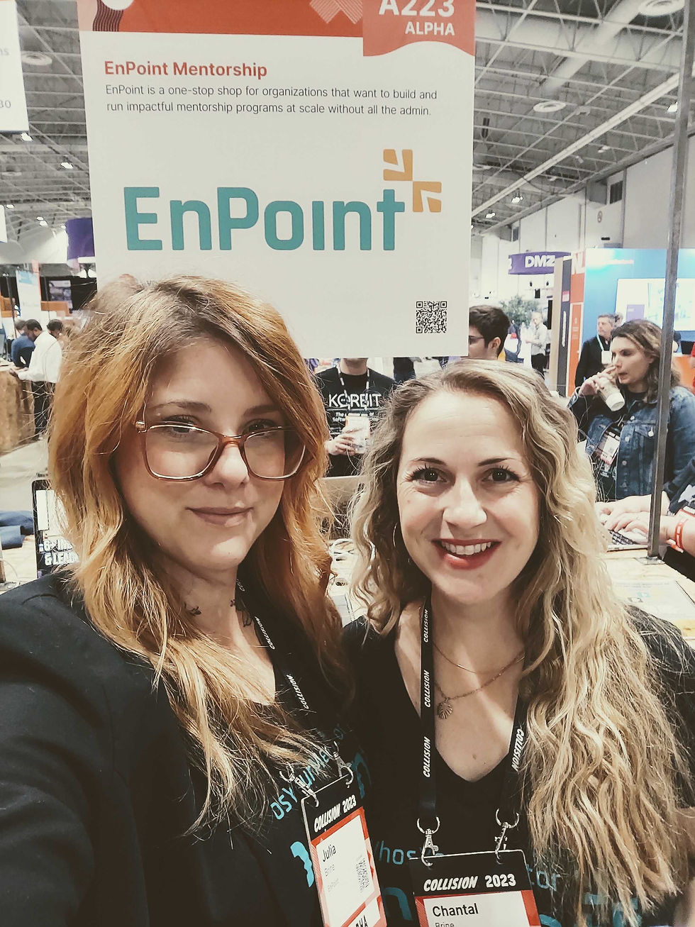Julia and Chantal smiling in front of a sign that says EnPoint