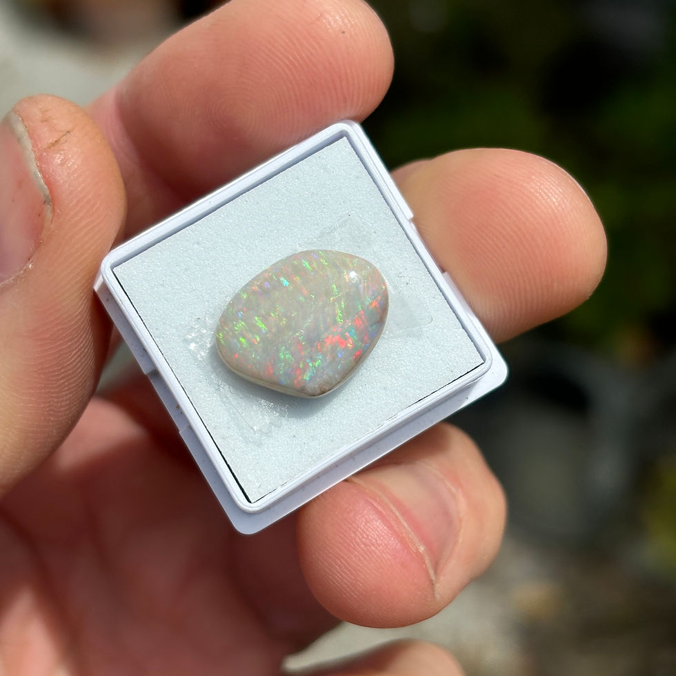 Free form white opal with a yellow, red and green fire pattern