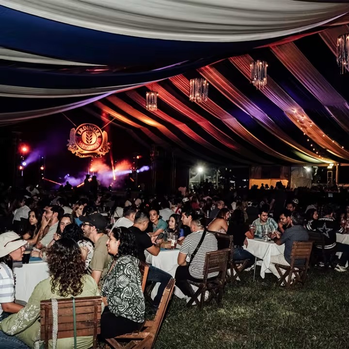 Carpa decorada con luces y asistentes en OtoñoBier Fest 2025 Guadalajara.