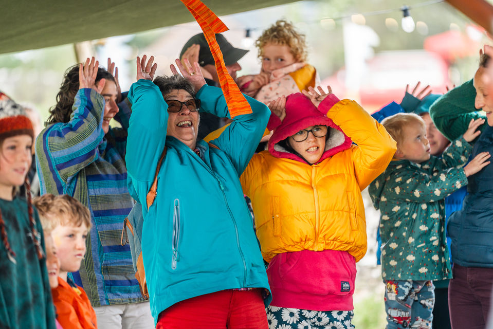 Parents and children performing a fun dance