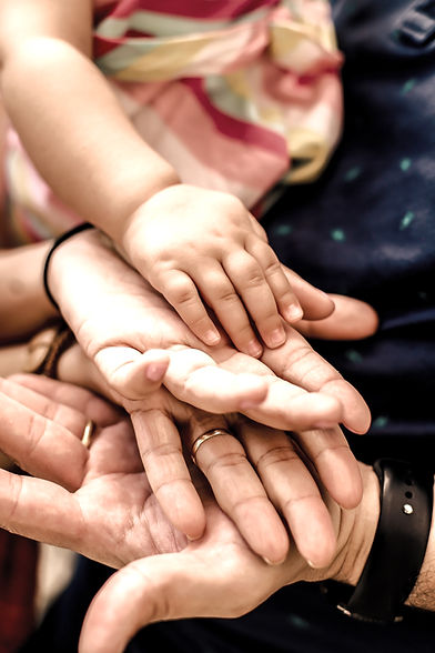 person wearing black watch holding babys hand_edited.jpg