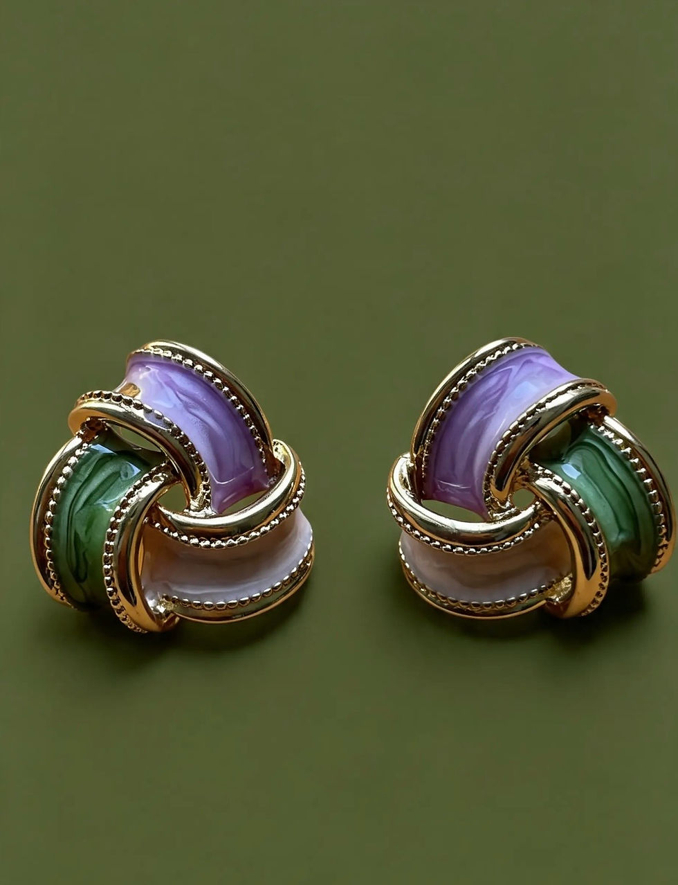 The Amara sculptural knot earrings with lilac, sage green and blush pink enamel woven thro