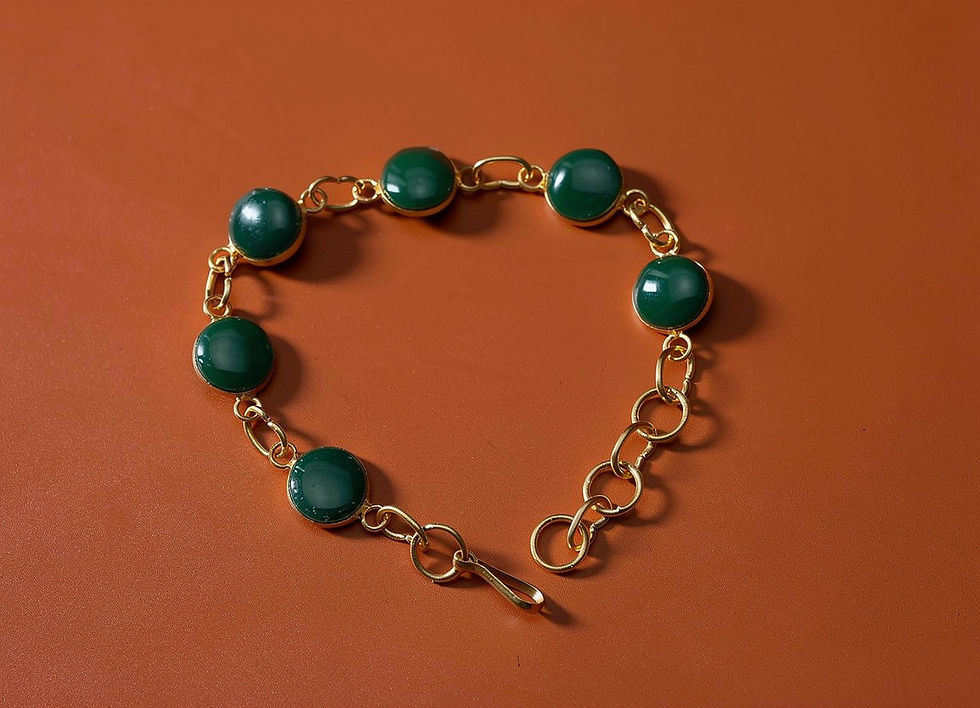 The Elara Green Onyx Bracelet with seven round green onyx cabochons in gold-plated bezel settings.