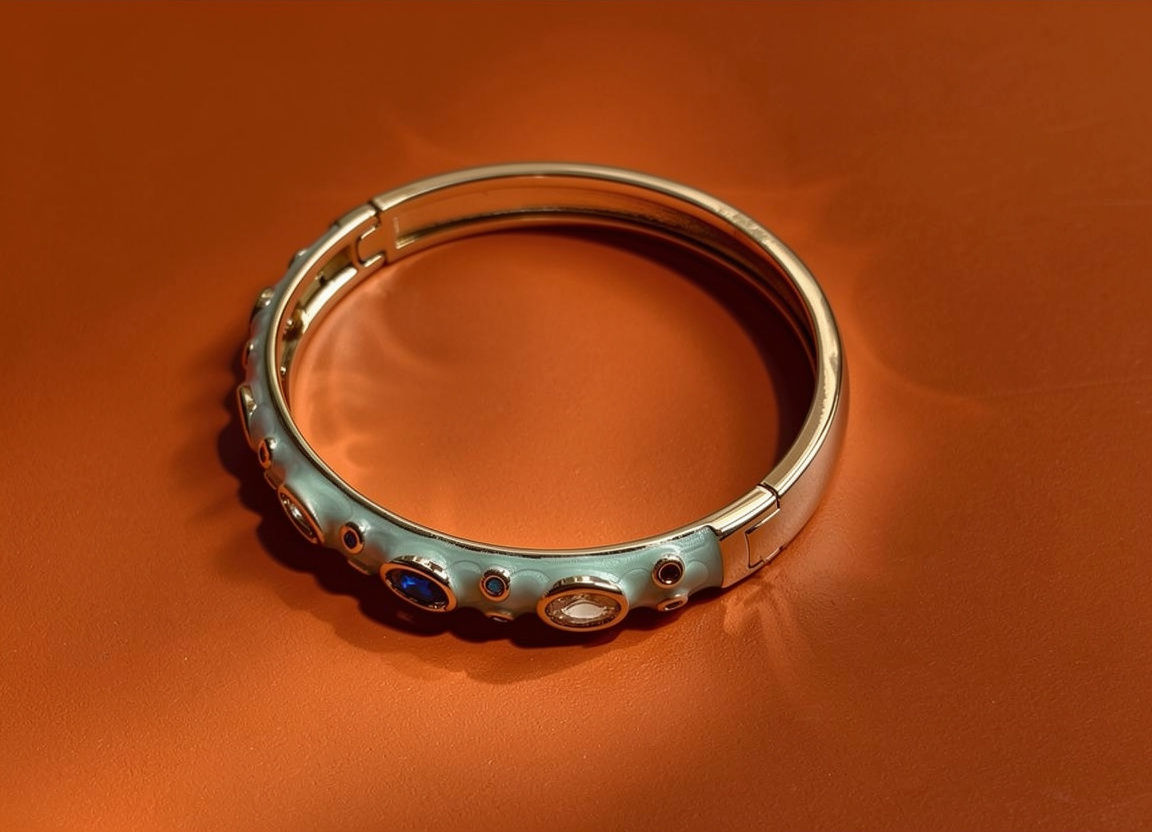 The Maaya bangle sets large oval glass stones across a mint green enamel body, with smaller round stones scattered