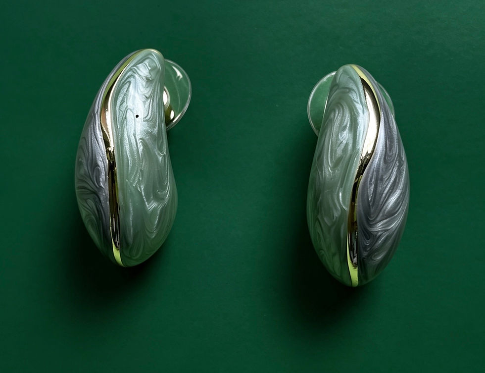 The Maaya Sage and Charcoal Marbled Drop Earrings featuring sage green and charcoal marbled enamel with a gold seam detail.
