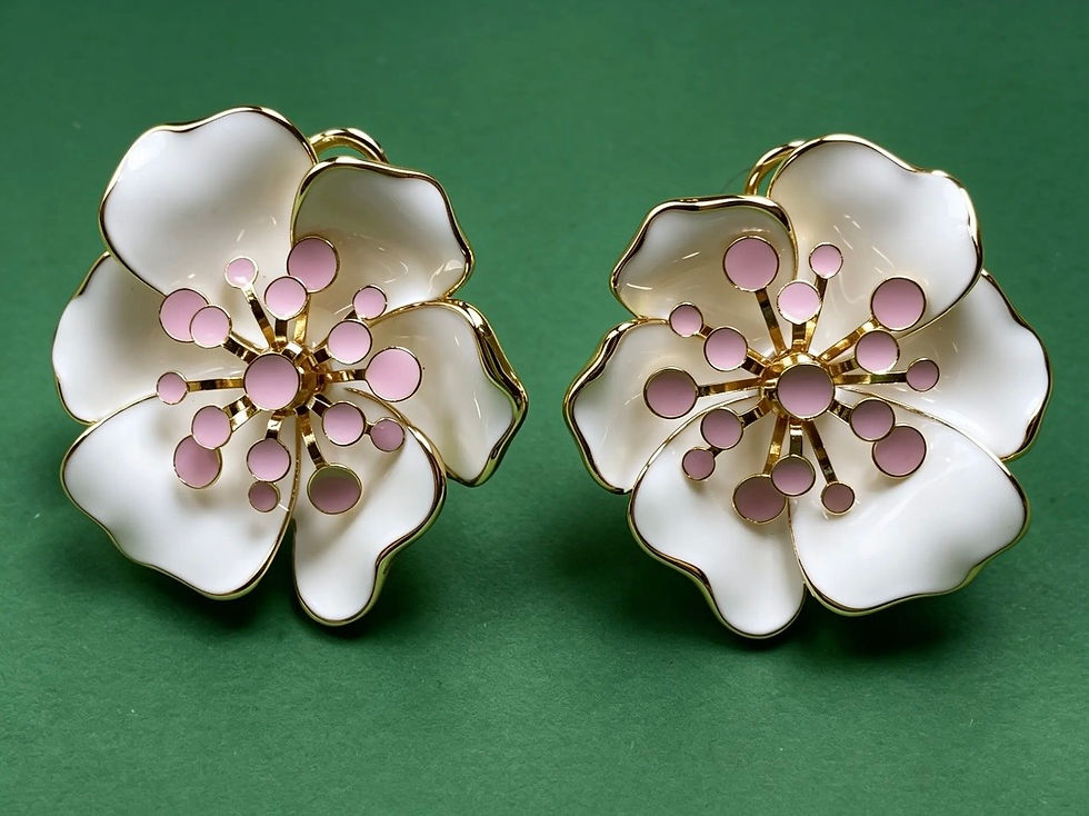 The Clara ivory white floral statement earrings with gold-plated brass, ivory enamel petals and soft pink bead centres.