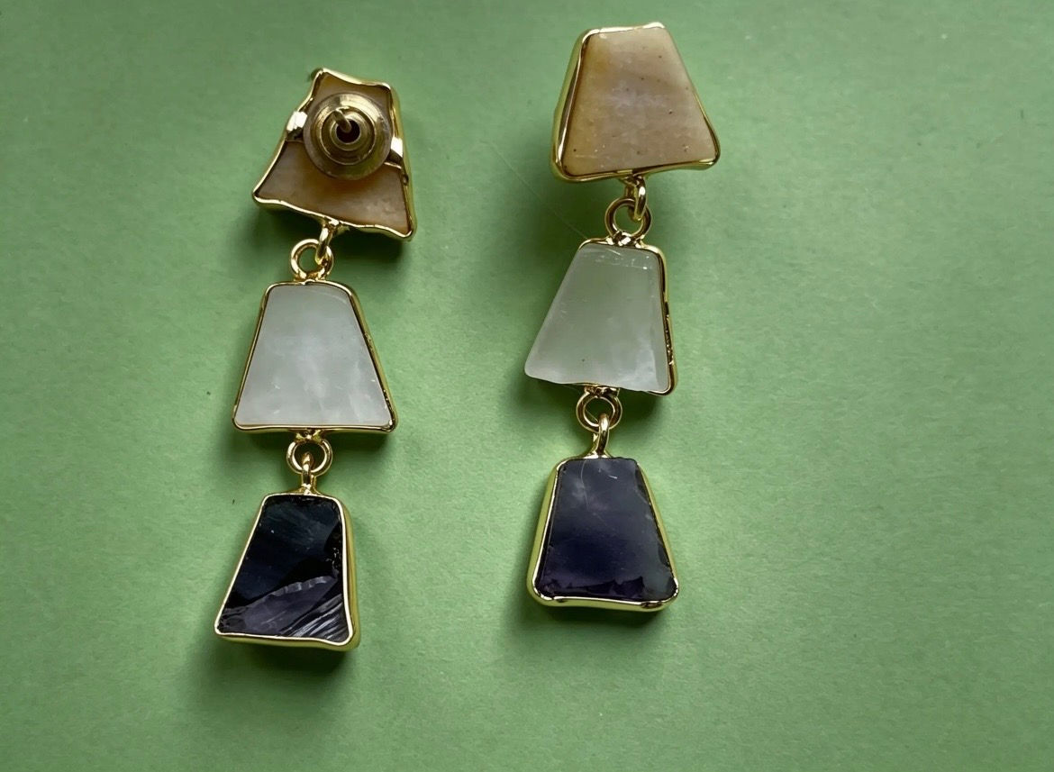 The Clara Agate Tiered Drop Earrings with natural honey, milky white and deep purple agate stones in gold-plated brass.