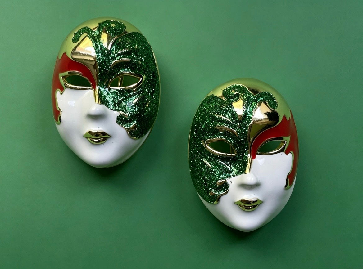 The Evelyn Venetian mask statement earrings with green glitter enamel, white enamel and gold-plated brass detailing.