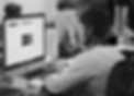 Man creating an A/B split test for email designs on a desktop monitor at an office desk