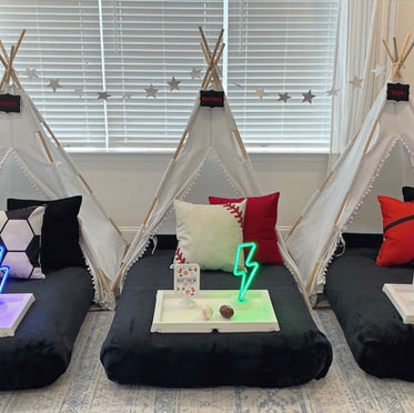 Sports-themed slumber party teepees with team-colored pillows, football , baseball and basketball props, neon lights, and star garlands to cheer on their favorite teams.