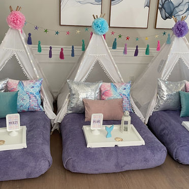Mermaid-themed teepee setup with ocean-inspired hues, scale-patterned fabrics, sequin pillows, seashell and starfish accents, and aquatic accessories for an under-the-sea escape.