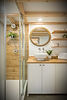 Bathroom with custom tle shower, oak vanity top and white vessel sink.