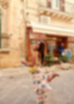 Solo female traveler smiling while exploring a sunny street in Puglia, Italy
