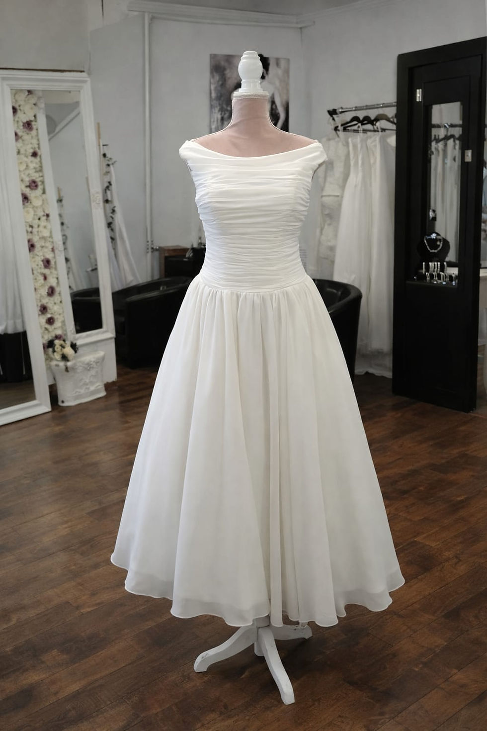 Elegant ivory tea length wedding dress with off the shoulder neckline and ruched bodice