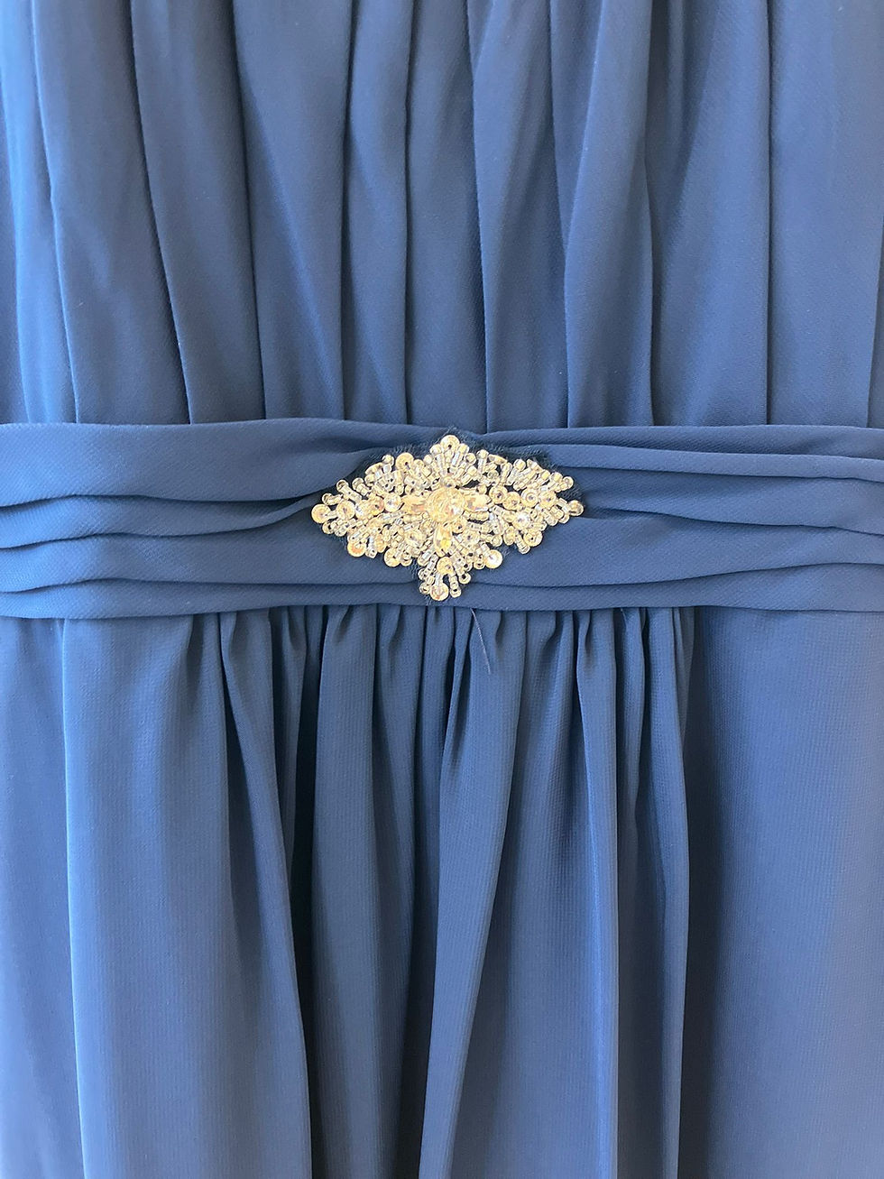 Deep royal blue child’s formal dress with pleated halter neckline, crystal waist and flowing chiffon skirt