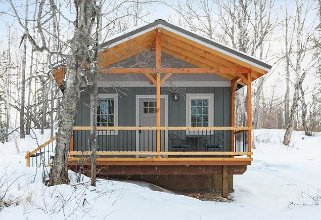 A beautiful exterior photo of cottage 2 in the wintertime