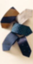 colorful patterned mix of ties arranged playfully