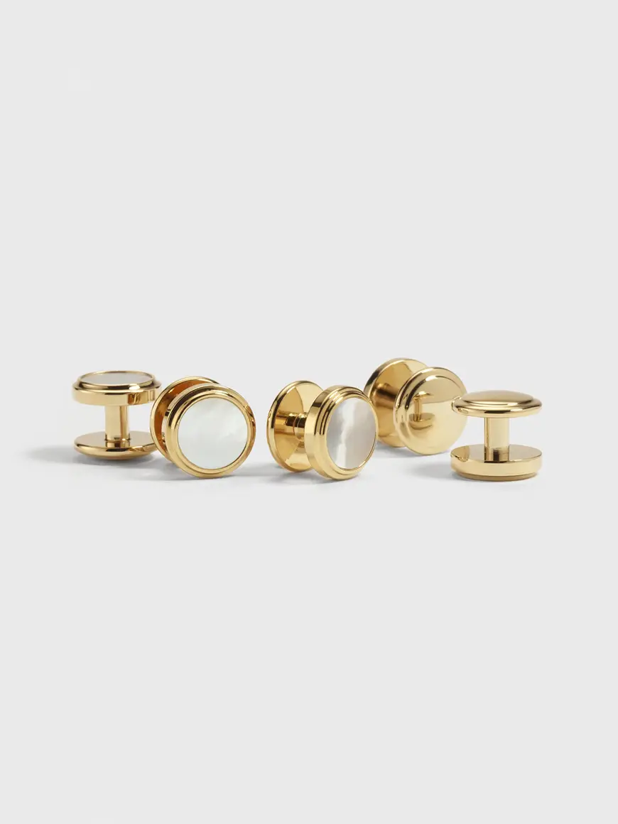 Pearl and gold stud buttons with a round design and polished finish