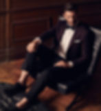man in a black tux (couch pose)