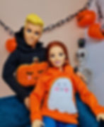 Barbie is wearing a Woven Tombstone Treat Orange Hoodie